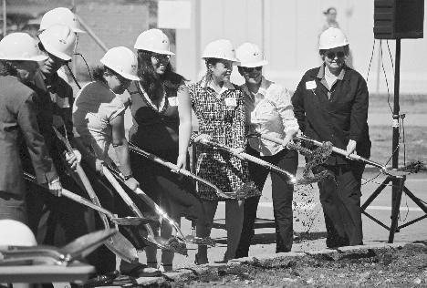 Current and former members of the Associated Students of Skyline College (ASSC) pose with dirt, shovels and hardhats at the groundbreaking of buildings 6 and 7A. (Neill Herbert)