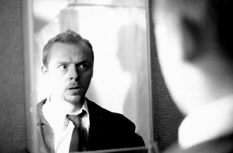 Shaun (Simon Pegg) realizes there is a zombie in his bathroom, and zombies everywhere else in Shaun of the Dead. (// www.imdb.com)
