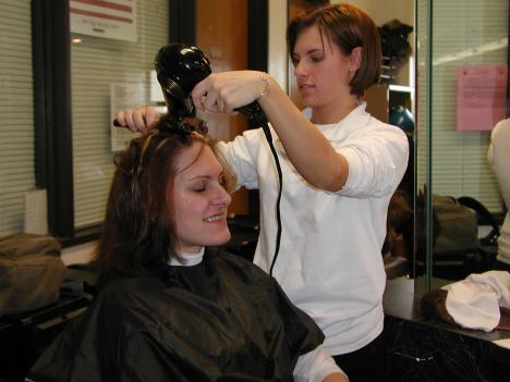 Cosmetology student Anna-Rose Aboud gives Katie Wallace an after-haircut blowdry. (Liezl Laurel)
