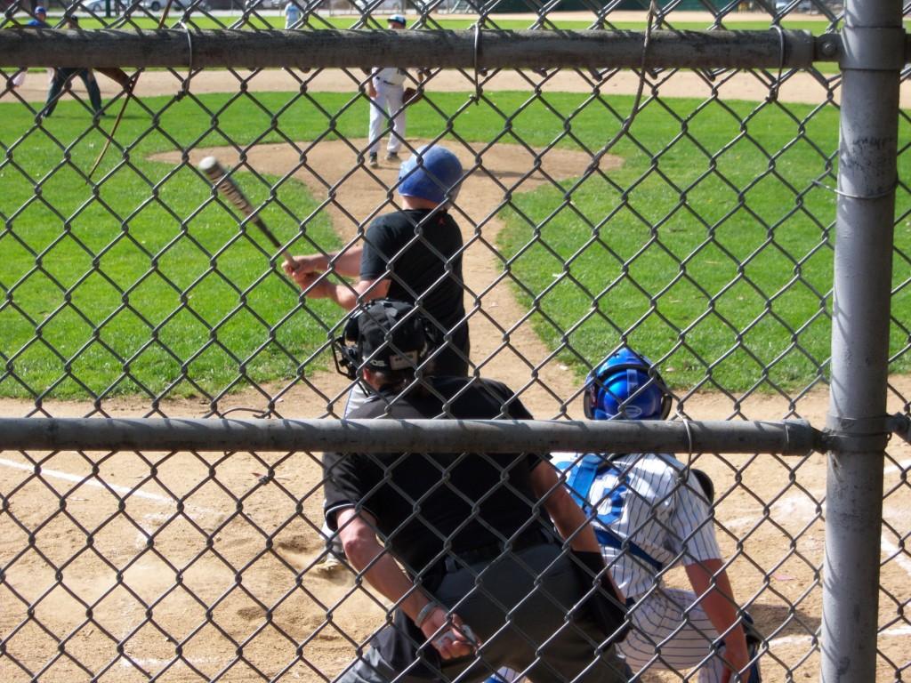 Little leaguers playing with a metal bat, possibly unaware of their dangers (Luis Osorio)