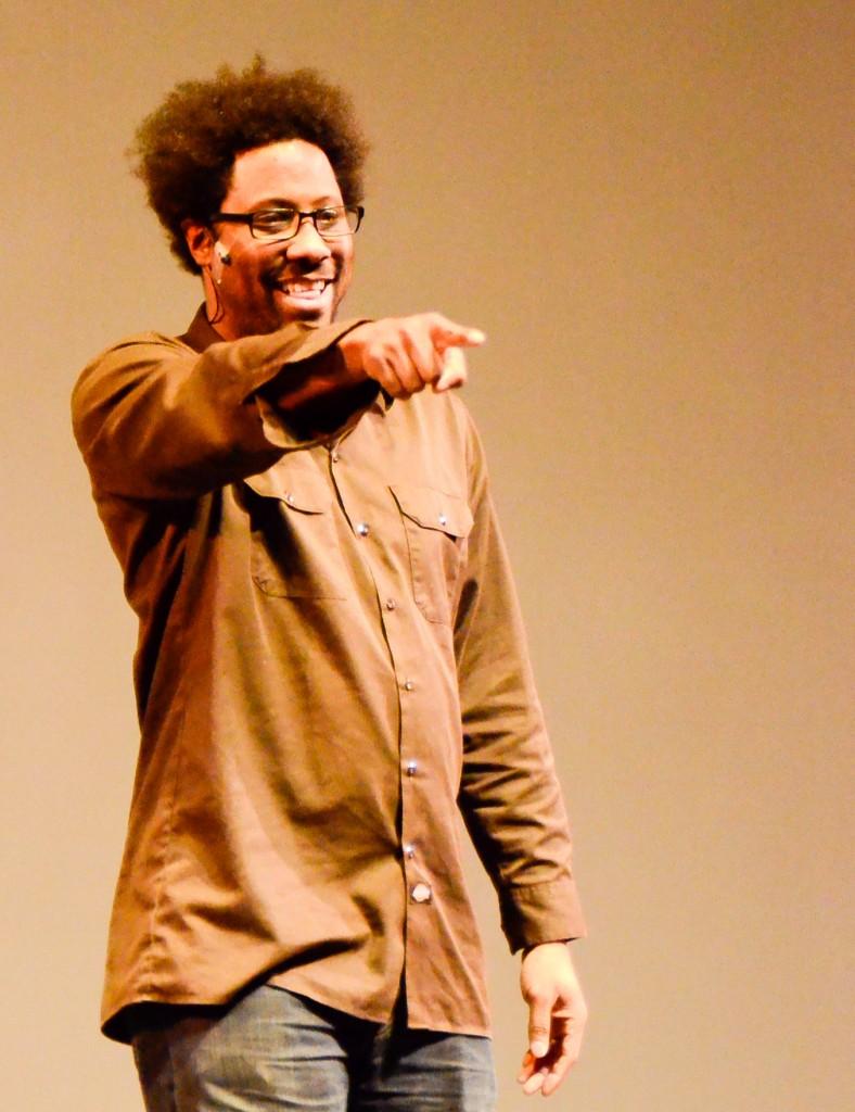 Comdian W. Kamau Bell points to the audience during his performance at Skyline College. (Robyn Graham)