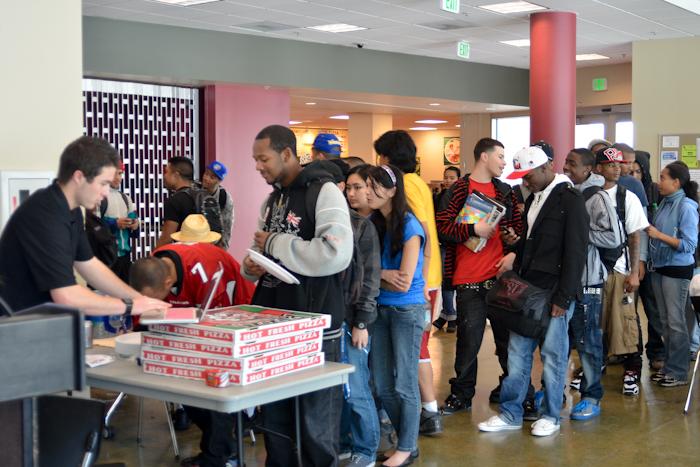 Students wait in line for pizza while Ray Paren­ti-Kurttila registers them for Relay for Life before giving them a slice on Wednesday Jan. 26, 2011. (Larry Crystal)