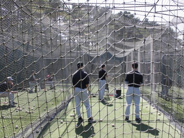 Students observe as hiting coach John Quintell explains the importance of squaring up to the ball. (Jonathon Chan)