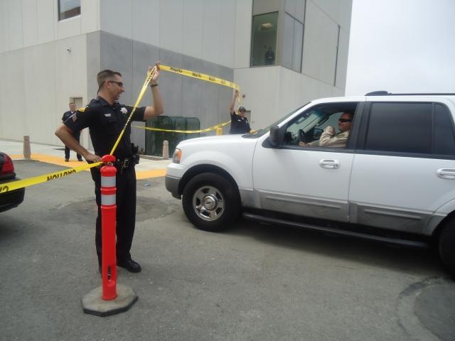 The Bomb Squad arrives, and has the caution tape lifted by a San Bruno Police Officer so the bomb squad can enter the scene. (JJ Valdez)