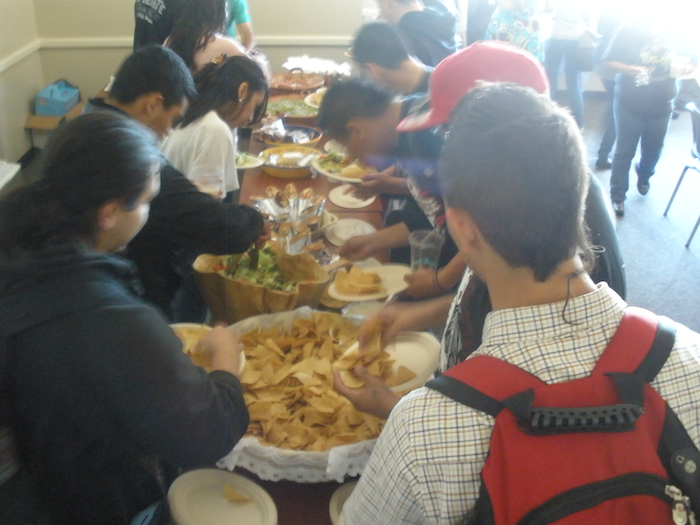 There was a feeding frenzy over burritos, chips, and guacamole after an Aztec dance performance. ()