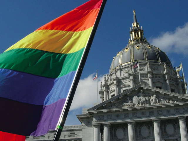 The+gay+pride+flag+flies+in+front+of+San+Francisco+City+Hall.+%28Jamison+Wieser%2FFlickr%2FCreative+Commons+License%29