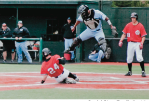 Catcher Colton Hicks slides into home safely. (Daniel Chee)