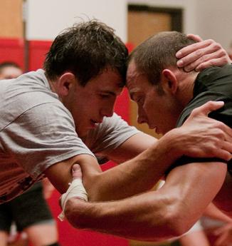 Wrestling team captain Tommy Howard (left) locks arms with Roman Ermolov.