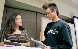 Jacqueline Escobar, transfer degree counselor, speaks to Anthony Ma, a student of Skyline College. 