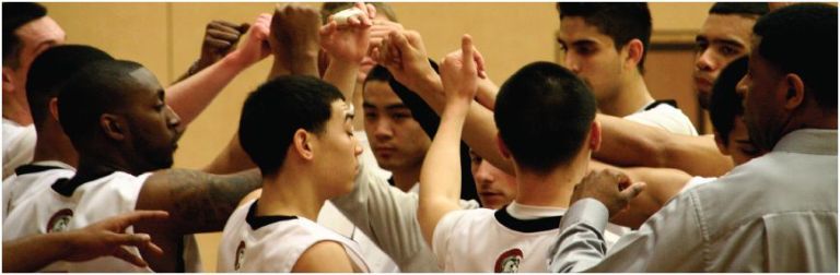 Last semester’s men’s basketball team huddle together during half-time.