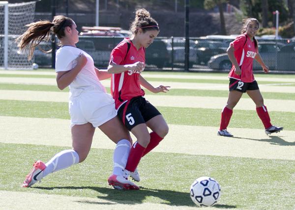 Skyline’s Rasha Shehadeh (right) is aggressively tackled by a Las Positas midfielder during the Oct. 23 match. Shehadeh suffered a crushed nerve in her foot as a result.