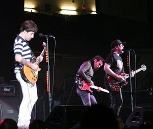 Fall Out Boy in concert. From left to right: Joe Trohman, Peter Wentz, Patrick Stump.
