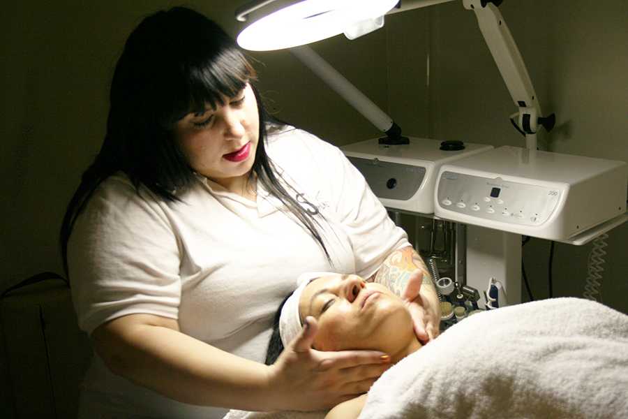 Michelle Rothman performing a facial on fellow student Patricia Woytek.