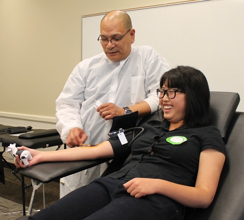 Jessica Hoe, student of Skyline, being prepped by RJ Cueva, a nurse of American Red Cross, for blood donation at Skyline College on May 7.