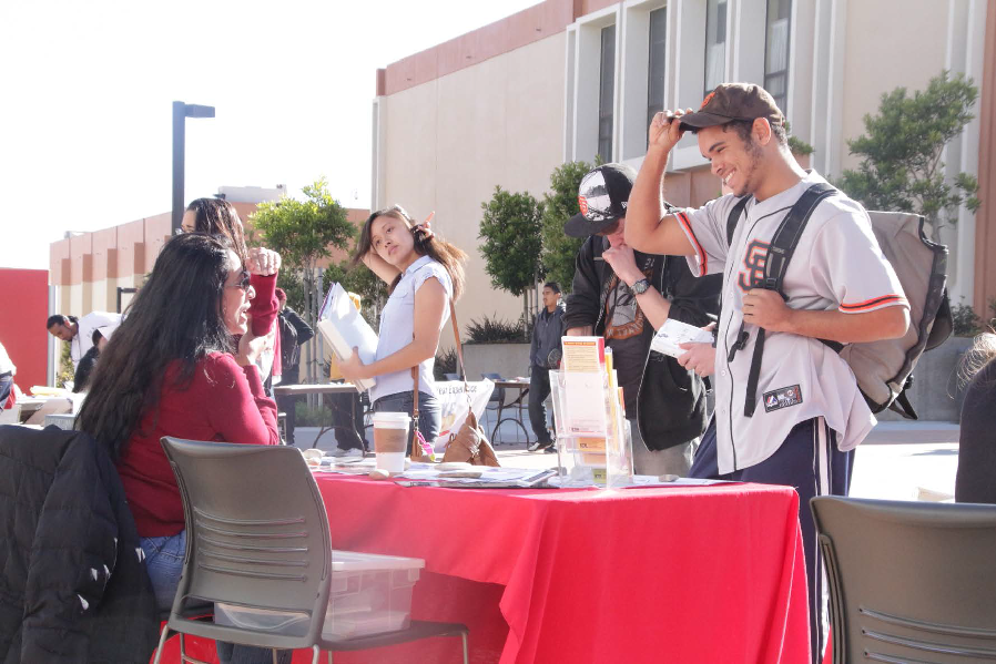 A member of the ASSC chats with a student during the club rush event.