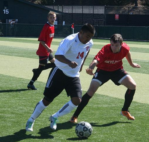 Trojans Juan Gomez (right) on the defense.