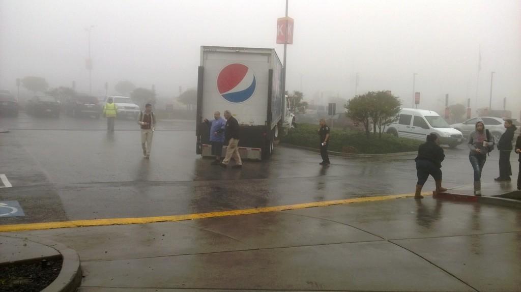 In the middle at the rear of the truck Chief of Public Safety Robert Dean in a black top can be seen talking with the driver, with one of his officers to the right and students surrounding them. 