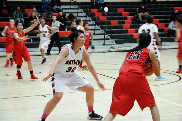 Trojans Janice Coronado (#30) blocking Las Positas Jasmine Rezonable (#15) while teammates struggle in the background. 