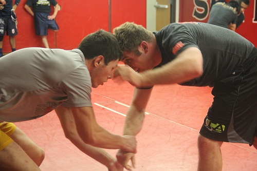 Skyline College Wrestler Coleman Maher (left) grappling with Galileo Wrestling Coach Allen Loretz (right) during a round robin wrestling practice in the Skyline College Mat Room. 5/14/14.