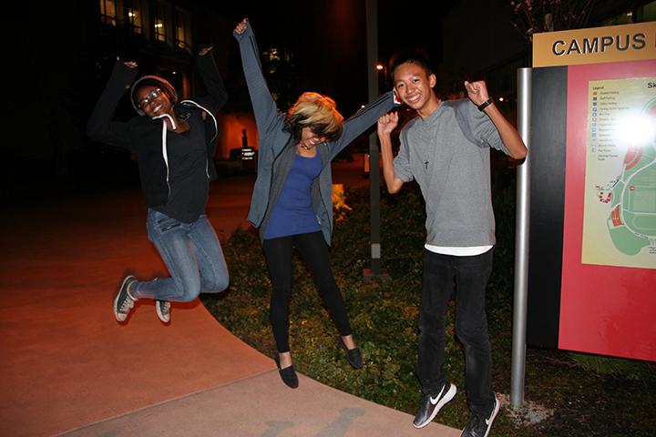 Students Serena Ogildbe, Elaine Rivera and AJ Yabot jump for joy after Giants win championship game.