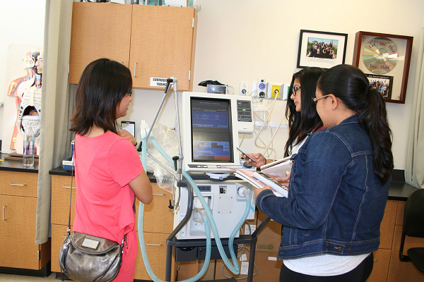 Rae De LaRosa (center) works in the respiratory therapy lab after class. The campus is exploring the idea of offering a bachelor’s degree in respiratory therapy.