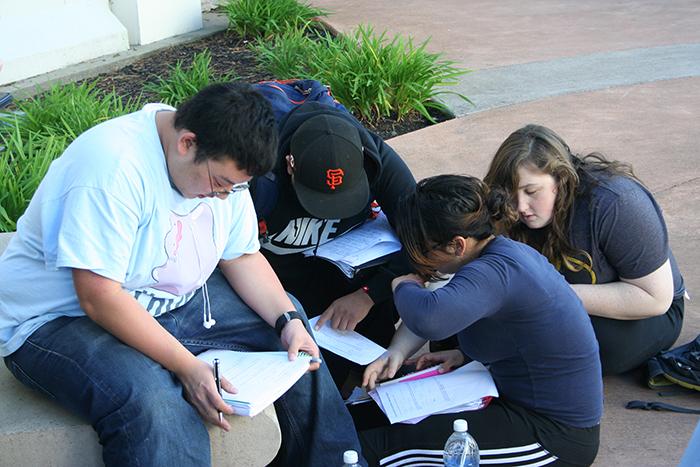 Students (from left) Jin Zhu, Brayan Rodriguez, Nancy Reyes and Laura Ziganti take advantage of the fire alarm by using the time to study as they await their Chem 192 test. 