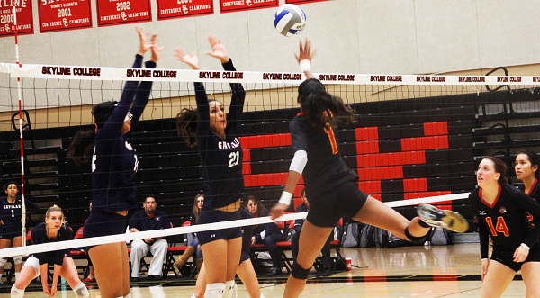 Sahara Clay middle blocker and outside hitter of Skyline team spikes the ball in heated match.