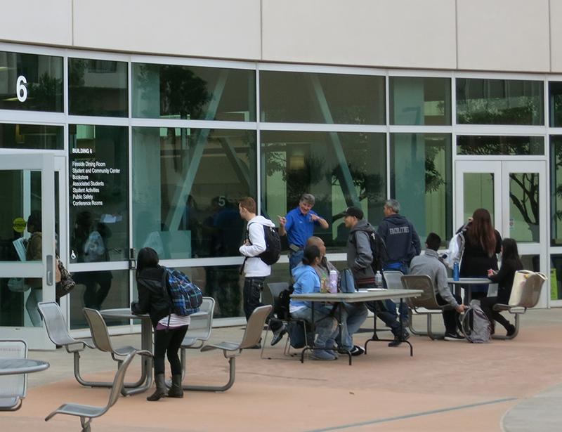 Senior Maintenance Engineer, Robert Spacher (center), ushered students back into building 6 after a short evacuation on Feb. 4, 2015.