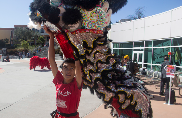 Skyline students enjoy the sights, sounds and tastes of Chinese New Year. Shaolin Cultural Center student Christopher Lawrence dons a traditional dragon costume for the ceremonies.