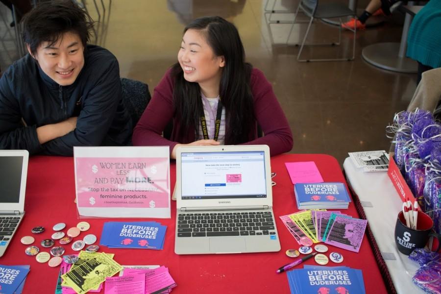 Kuang Yang (left) and Michelle Chee (right) from ASSC take petitions to stop tax on feminine hygiene products in the Fireside Dining Room on Wednesday, March 16, 2016. 