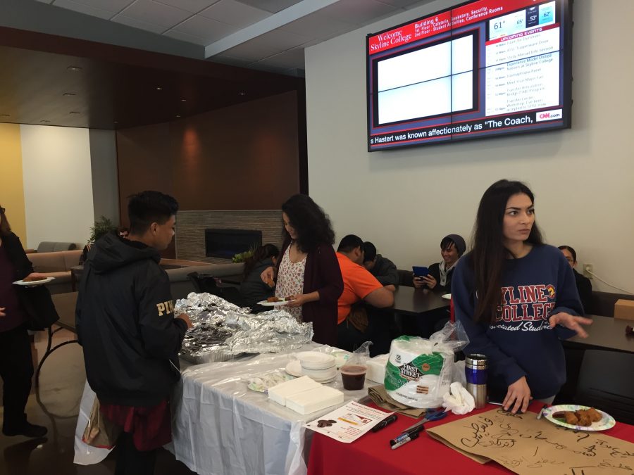 Skyline students Nena Darwin and Khin Thar are serving Halal food in the Fireside Room in building six on April 11 during the Islam 101 event to students. 