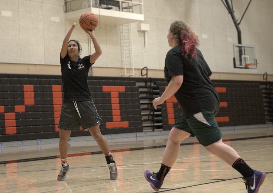 Ariana Sheehy (left) taking a shot at the basket during practice. 