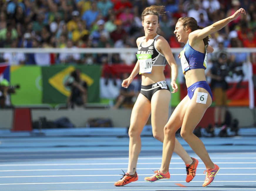 Nikki Hamblin (left) encourages Abbey DAgostino to the finish line earning both competitors Fair Play awards from the International Fair Play Committee.