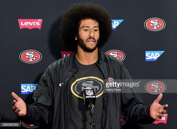 Colin Kaepernick addressing the media on the background of his protest.