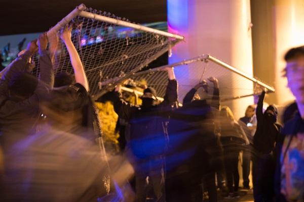 Protesters take down fences to create a path onto Interstate 580 on Nov. 11, 2016 in
Oakland, Calif.