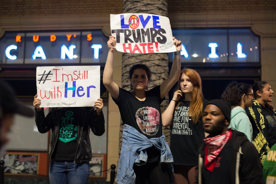 Protesters+hold+signs+denouncing+President-elect+Donald+Trump%E2%80%99s+campaign+on+Nov.+10%2C+2016+in+Oakland%2C+Calif.