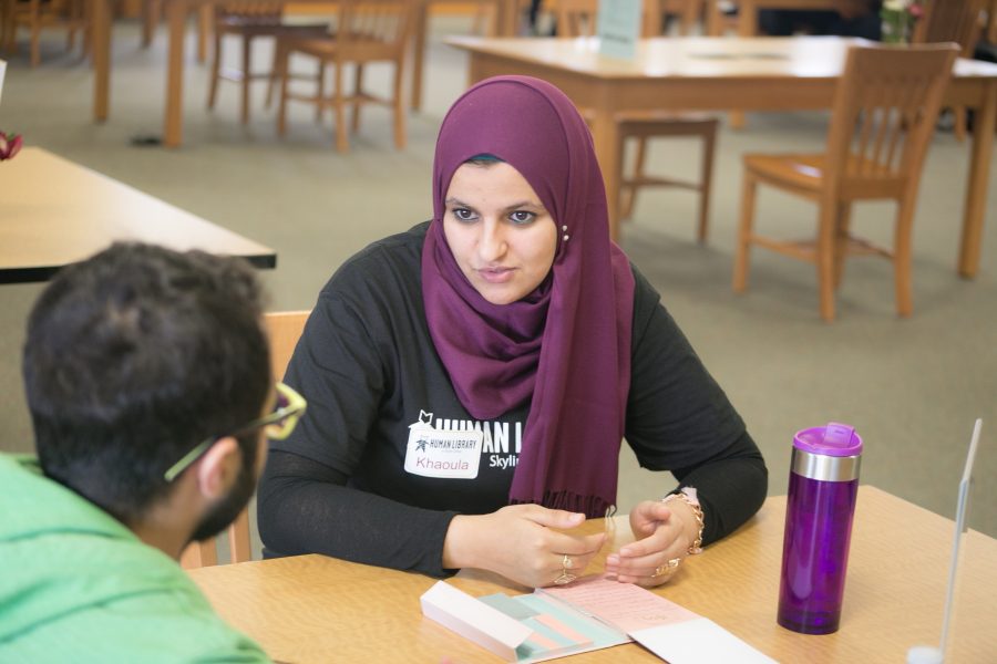 Khaoula Aissaoui and a student talking at one of the tables available at the Human Library event. 