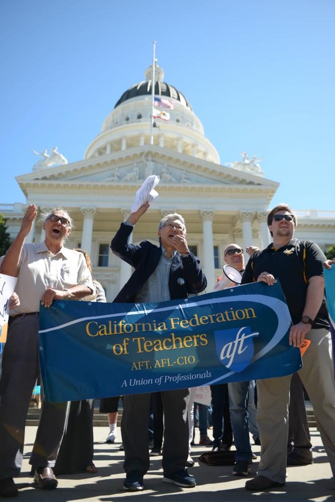 Dean Murakami from the California Federation of Teachers rallies protestors at the California State Capitol Museum on March 31, 2017. 
