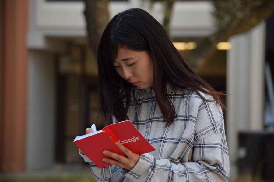 Kae Yoshii making notes in her notebook at Skyline College