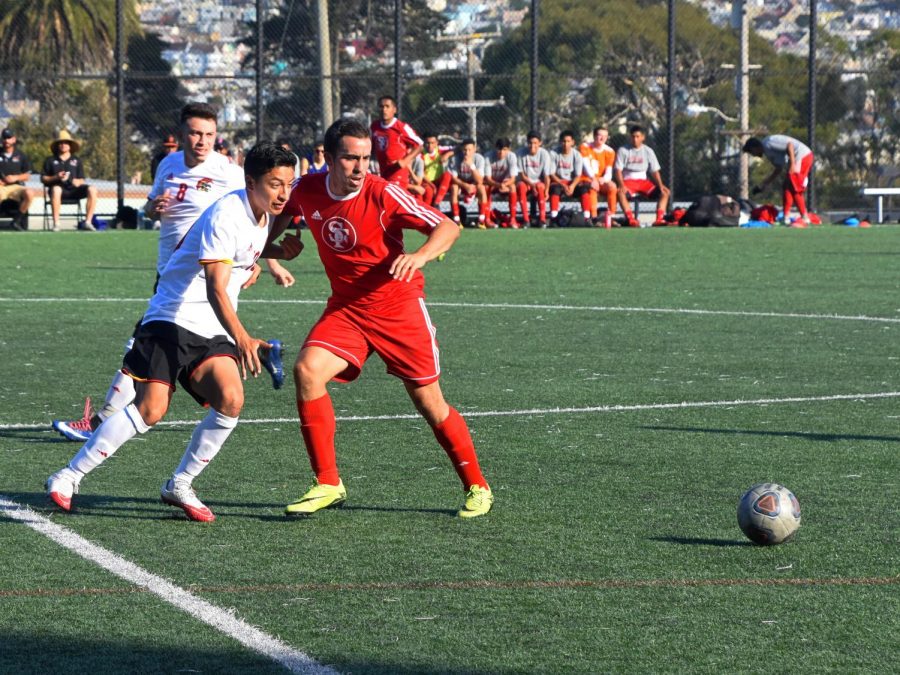 Isai Flores and a City College of San Francisco defender compete for control of the ball.