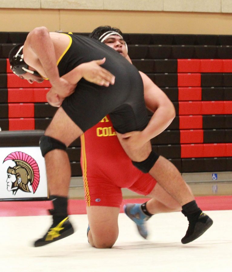 Lucas Cruz double legs his opponent for a two-point takedown at Skyline College against Chabot College on Nov. 8, 2017 Photo credit: Christian Magallanes