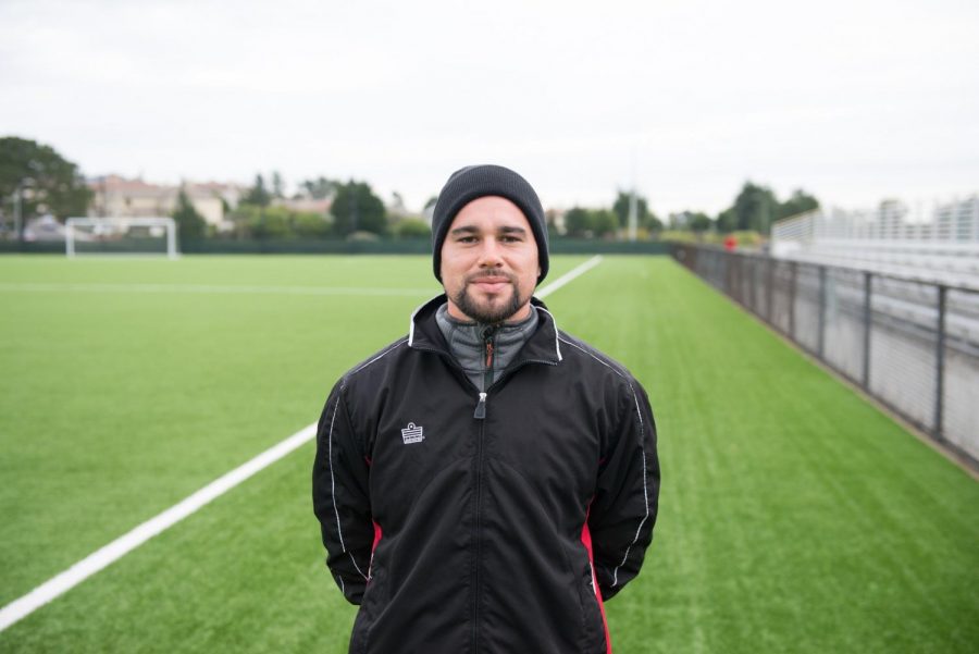 Assistant coach Stephen Cordova stands in front of the field before practice on Nov. 15, 2017.