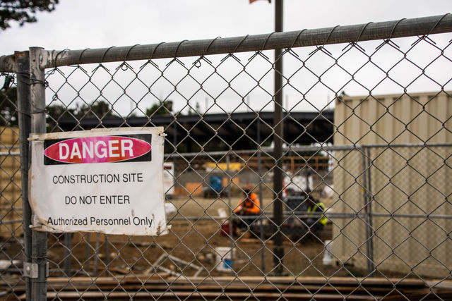 ‘Danger’ signs hang on the fences that line the construction site of the new environmental sciences building on Wednesday, Aug. 29, 2018.