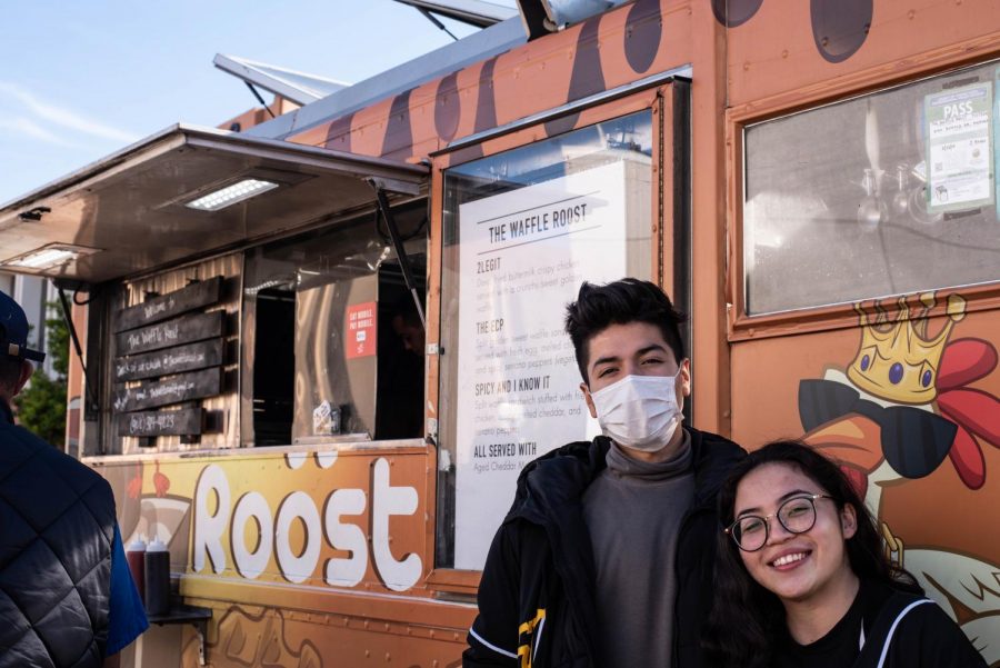 Tuesday, 3 Dec. Alejandro Guzman (left) and Marie Kyla Perez (right) are here seen in front of a food truck on the 50th Anniversary bbq at Skyline College