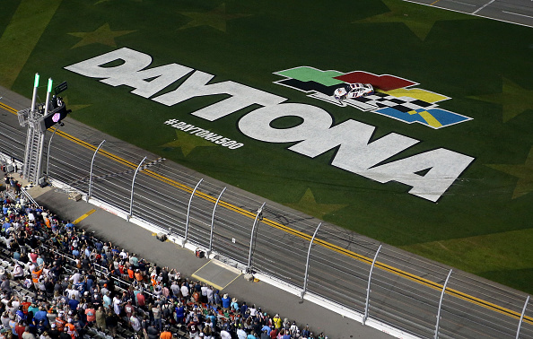 DAYTONA BEACH, FL - FEBRUARY 17:  Denny Hamlin, driver of the #11 FedEx Express Toyota, celebrates with a burnout after winning the Monster Energy NASCAR Cup Series 61st Annual Daytona 500 at Daytona International Speedway on February 17, 2019 in Daytona Beach, Florida.  (Photo by Brian Lawdermilk/Getty Images)