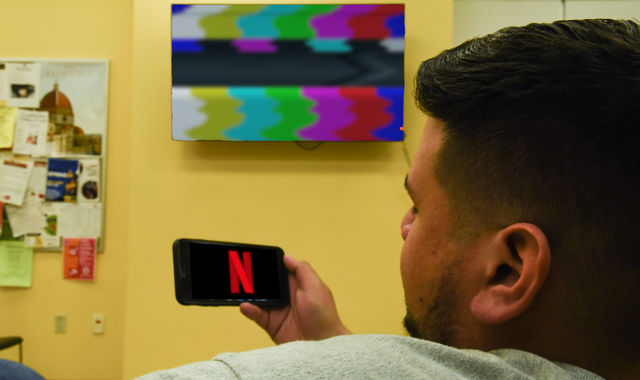 In this photo illustration a Netflix logo seen displayed on a smartphone