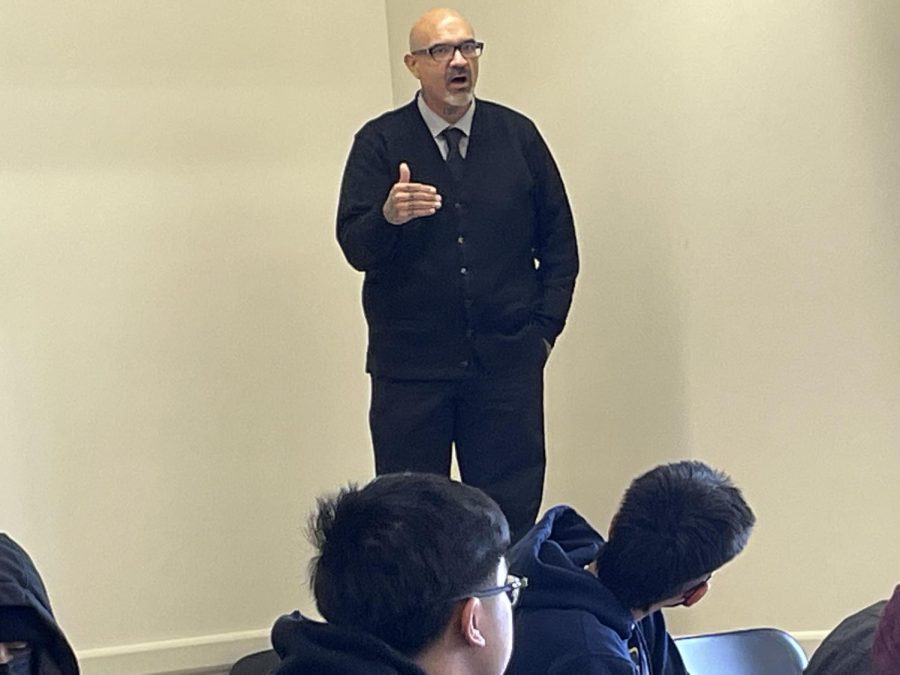 John Ulloa stands on a desk to better instruct his students during a History of Ethnic Groups in US class at Skyline College in San Bruno, California