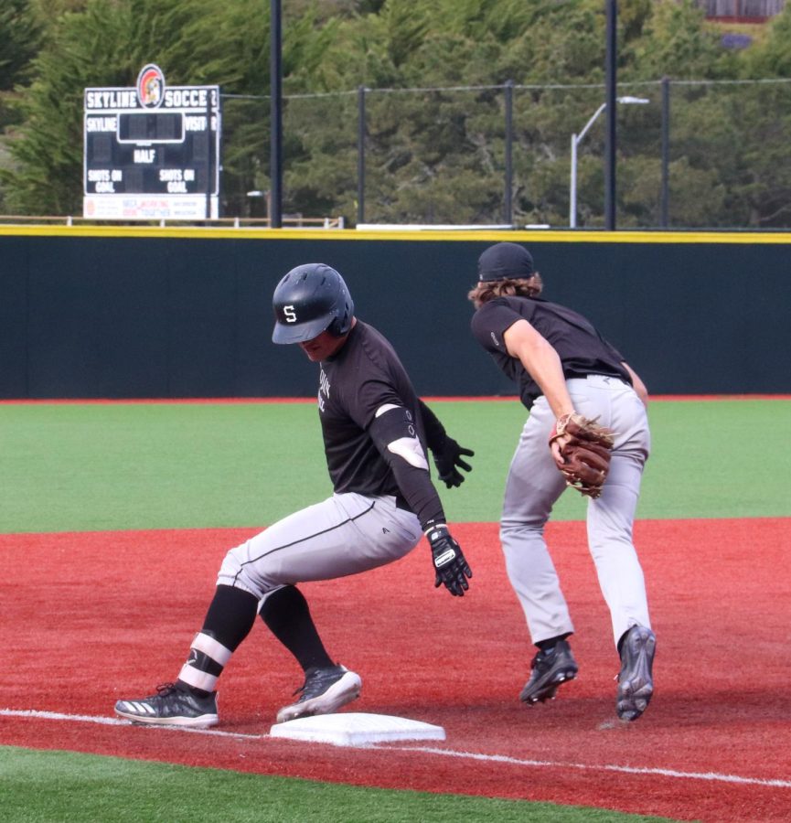 A baseball player attempts to take out another player at third base during practice at Skyline College on Feb. 15.