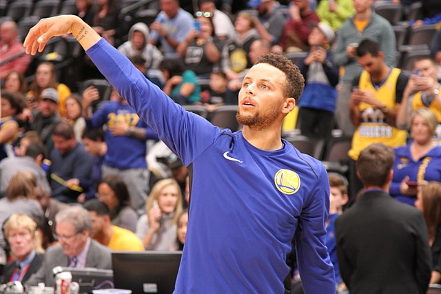 Stephen Curry shoots a three during a pregame shootaround in Denver.