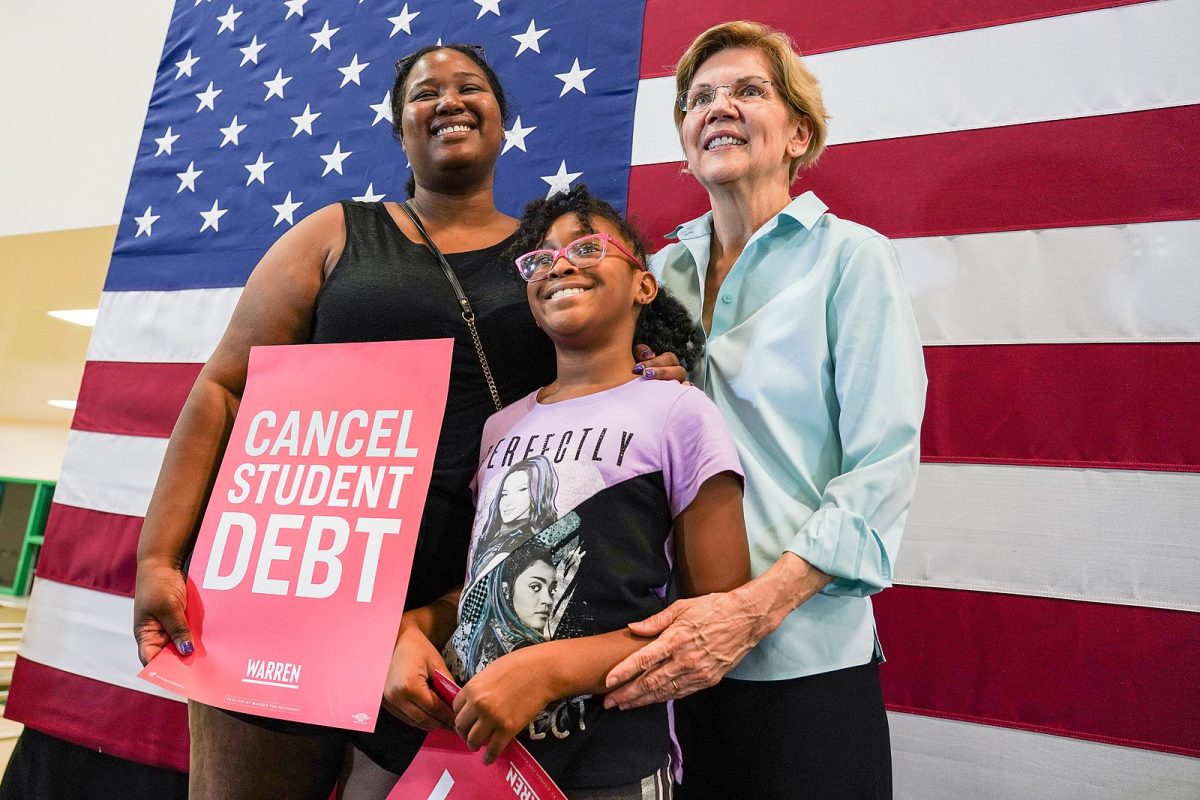 U.S. Senator Elizabeth Warren stands alongside two attendees at her 2019 campaign event in Henderson, Nevada.